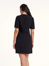 the back view of a lady in black a-line mini dress
